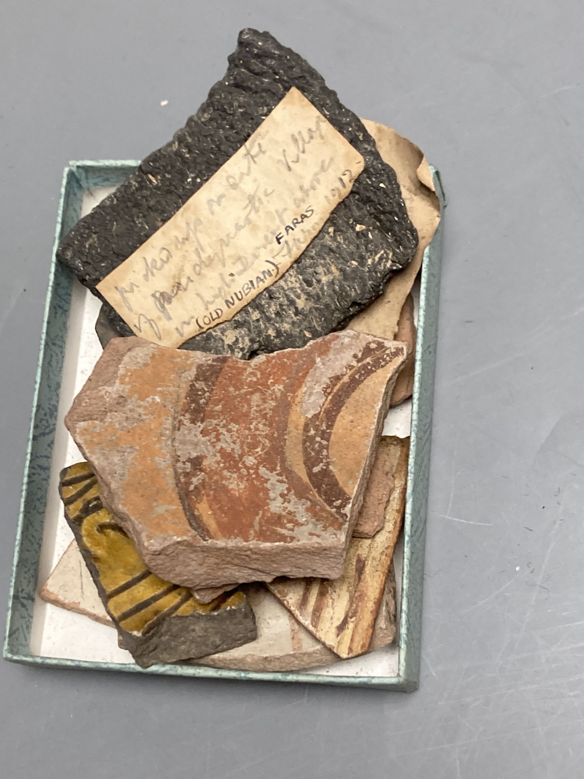 A group of Egyptian pottery fragments, Coptic period, together with a Syrian Islamic pottery oil lamp fragment
